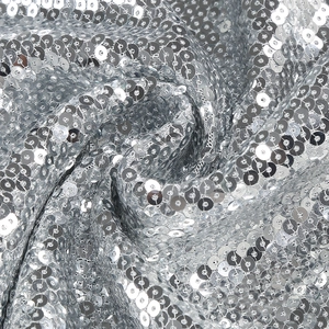 Macro shot of silver sequin fabric detailing the high-density circular sequins and texture