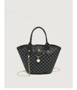 Detail of black tote bucket bag with vintage floral pattern and white pearl charm accessory