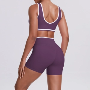 Detail view of purple yoga set featuring U-shaped back design and white contrast piping