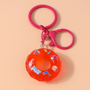 Detail of pink keychain with liquid-filled orange charm featuring sea life miniatures