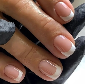 Classic french tip press-on nails in nude pink and white with a glossy salon finish