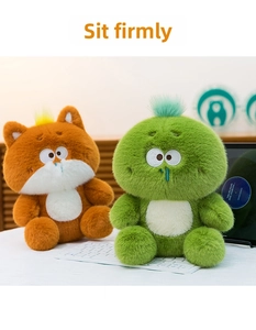 Detail of plush monster and cat toys with long fluffy fur sitting on a desk