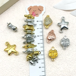 Star and heart shaped magnetic jewelry clasps shown with a ruler for size reference
