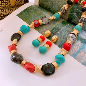 Detail of vintage bohemian jewelry set with colorful marble beads and gold textured spacers