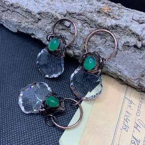Close-up of vintage bronze maple leaf pendant with green agate and crystal details