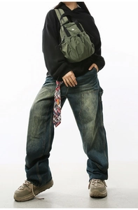 Detailed view of vintage wide-leg cargo jeans with distressed yellow-green wash and pockets