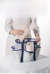 Close-up of mesh beach bag showing multiple storage pockets and Beach Love logo
