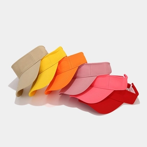 Multiple bright colors of minimalist sun visors with detailed canvas fabric texture