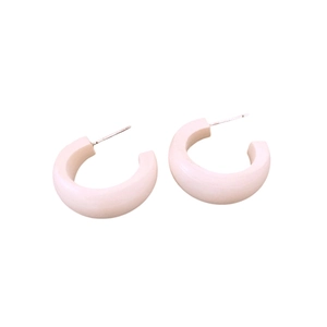 Minimalist white C-shaped wooden stud earrings with silver needle on white background