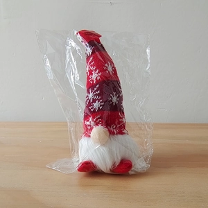 Glow Christmas gnome doll with white beard and red snowflake hat in clear packaging