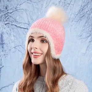 Pink winter knit beanie for women with white pom-pom and warm fleece lining for cold weather