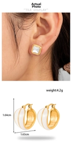 Detail view of gold-plated cream enamel hoop earrings with product dimensions and weight
