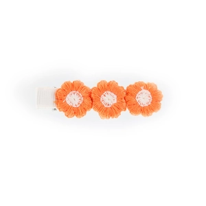 Detail of three-flower crochet hair clip with orange petals and soft white centers