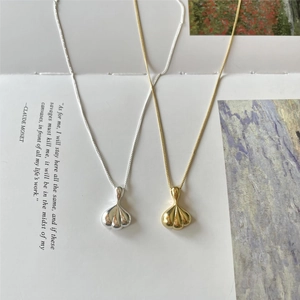 Minimalist 925 sterling silver necklaces in gold and silver finish on artistic background