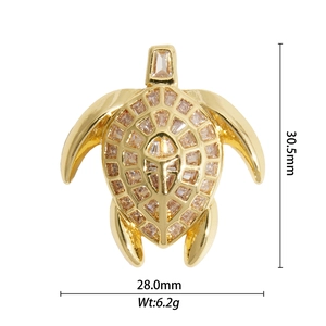 Macro view of gold turtle pendant with crystal stones showing 30.5mm x 28.0mm dimensions