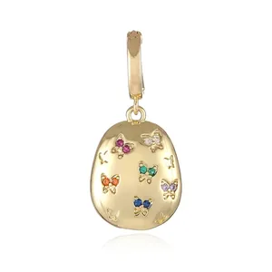 Detailed close-up of 18k gold-plated oval pendant with colorful butterfly crystal inlay