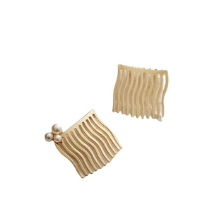French retro style gold wavy hair combs set with pearls on white background