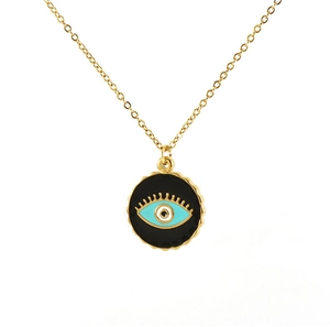 Detail of gold chain necklace with black Evil Eye pendant featuring blue and white center