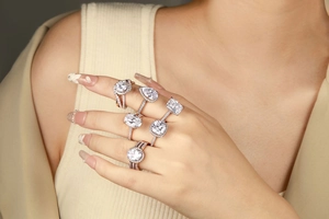 Detailed view of sterling silver rings with pear, oval, and square halo-set zircon stones