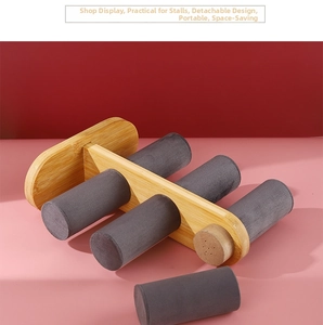 Macro detail of 3-tier bamboo jewelry stand featuring removable grey velvet cylinder bars