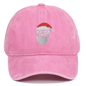 Close-up of pink washed cotton baseball cap featuring detailed Santa Claus embroidery