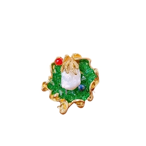 Vintage gold baroque pearl brooch with green texture and colorful beads on white background