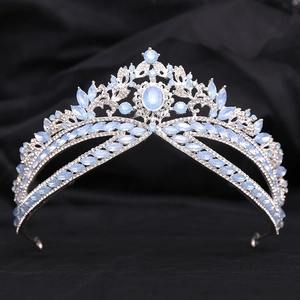 Detailed view of silver bridal crown with pale blue crystals on black fabric background