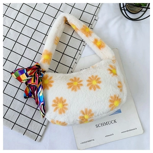 Close-up of fluffy white plush handbag with orange daisy prints and plaid silk scarf