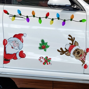 Close-up of magnetic Christmas car decals featuring Santa, reindeer, and colorful light bulbs