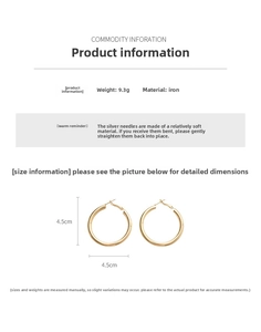 Detail view of 4.5cm gold hoop earrings with 9.3g weight and silver needle pins