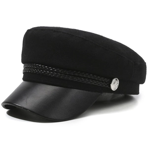 Detail view of the black newsboy cap featuring wool-like fabric and textured PU leather brim