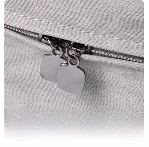 Close-up of dual metal zippers on grey textured PU leather travel toiletry storage bag