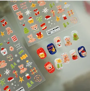Detailed view of 3D embossed Christmas bear and snowflake nail stickers on nails