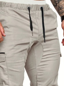 Detailed view of elastic waistband with black drawstring and side cargo pockets on men's pants
