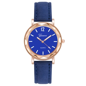 Detailed view of blue quartz watch with faceted rose gold case and leather strap
