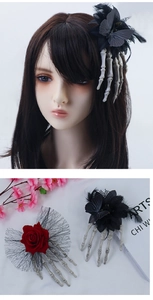 Macro shot of Gothic Halloween hair clip with skull claw, red rose, and black lace veil