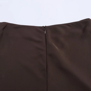Detailed close-up of dark brown satin skirt featuring a seamless invisible zipper closure