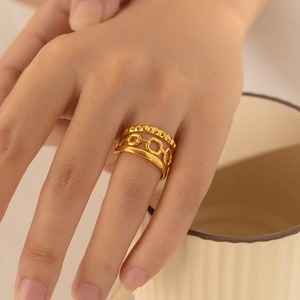 Detail shot of multi-layer gold plated stainless steel ring with geometric chain texture