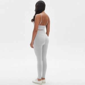 Detail of high-waist yoga leggings and strapless sports bra in breathable grey knit