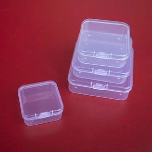 Macro detail of transparent PP plastic storage boxes with secure snap buckles on red base