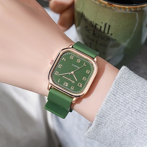 Close-up of square quartz watch with grass green silicone strap and rose gold metal case
