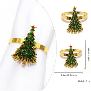 Golden napkin ring featuring a green enamel Christmas tree with red rhinestone accents