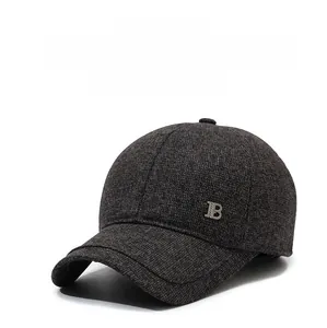 Detail of dark gray winter baseball cap showing thick wool texture and metal B logo