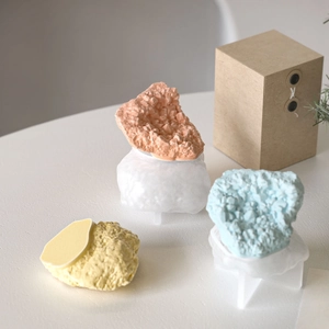 Detail of 3D rock resin molds showing pink and blue crystal stones in a gift box