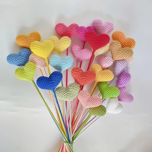 Handmade crochet heart bouquet with vibrant colorful yarn flowers on white background