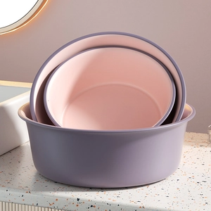 Three-piece nesting washbasin set in contrasting purple and pink minimalist plastic