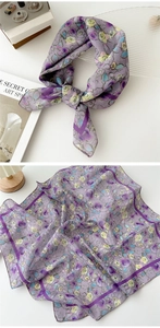 Detail of a purple floral cotton linen scarf showing soft texture and petal patterns