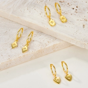 Detailed view of S925 silver gold hoop earrings with star engraved geometric charms