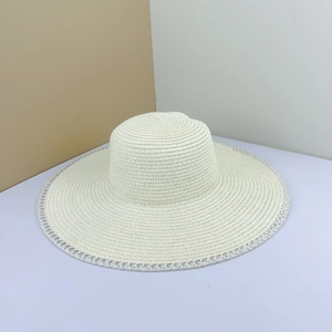 Elegant wide brim straw sun hat with scalloped lace edges for beach and summer vacation