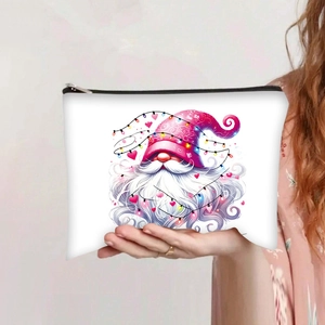 Detail of white canvas makeup bag featuring holiday gnome illustration and zip closure